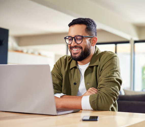 Man smiling while talking on mobile phone
